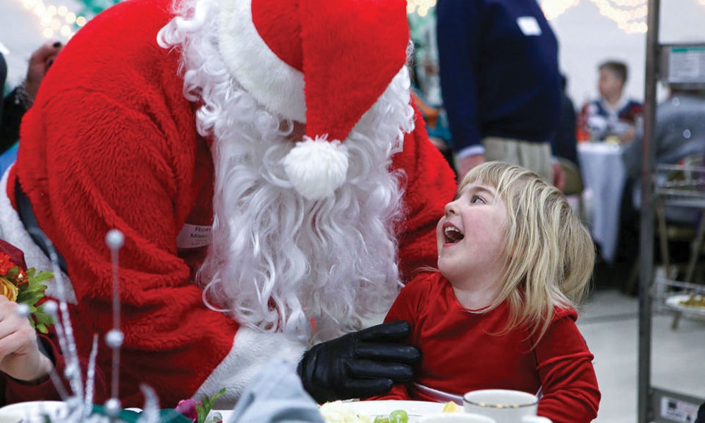 Young girl laughing with Santa